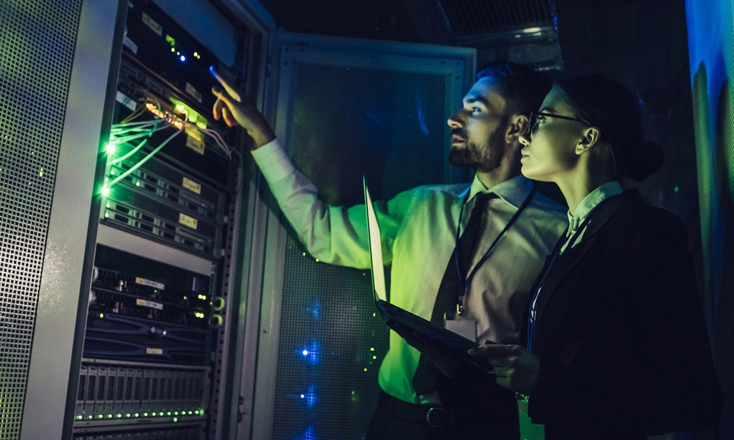 Two people standing at a data center rack
